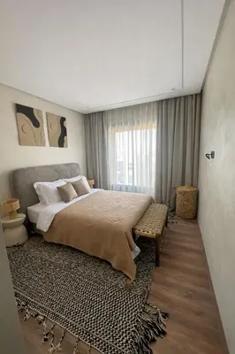 a bedroom with a large bed and a window at Cozy & Modern Gueliz Apartment in Marrakech
