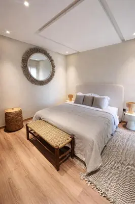 a bedroom with a large bed and a mirror at Cozy & Modern Gueliz Apartment in Marrakech