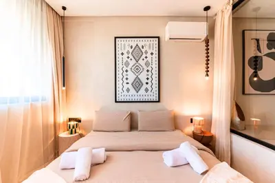 a bedroom with a bed with two towels on it at Suite Tifawt - Central, Design & Lumineux in Marrakech