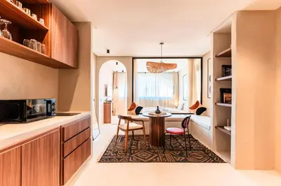 a kitchen with a table and chairs in a room at Suite Tifawt - Central, Design & Lumineux in Marrakech
