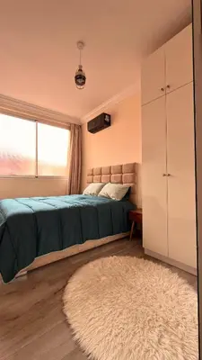 a bedroom with a bed and a window and a rug at Your Hidden Oasis, Quiet, Cozy and Charming in Marrakech