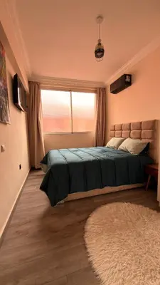 a bedroom with a large bed and a window at Your Hidden Oasis, Quiet, Cozy and Charming in Marrakech