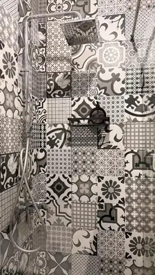 a bathroom with black and white tiles on the wall at Your Hidden Oasis, Quiet, Cozy and Charming in Marrakech
