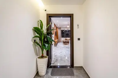 a hallway with a plant in a white vase at Moonlight Suite Pool and Relaxation in Marrakech