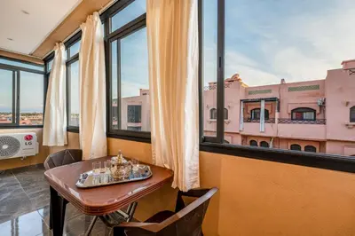 a dining room with a table and a window at Moonlight Suite Pool and Relaxation in Marrakech