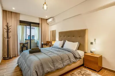 a bedroom with a large bed in a room at Moonlight Suite Pool and Relaxation in Marrakech