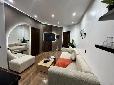 a living room with a couch and a table at Studio sur guiliz avec piscine et parking in Marrakech