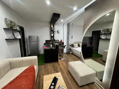 a living room with a couch and a table at Studio sur guiliz avec piscine et parking in Marrakech