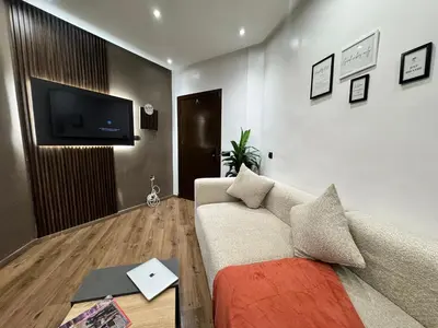 a living room with a couch and a flat screen tv at Studio sur guiliz avec piscine et parking in Marrakech