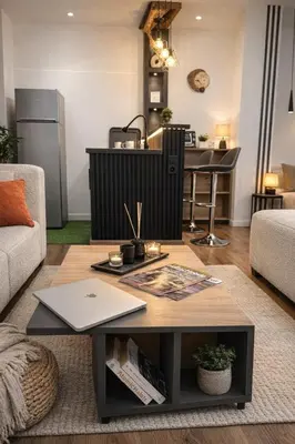 a living room with a coffee table and a kitchen at Studio sur guiliz avec piscine et parking in Marrakech