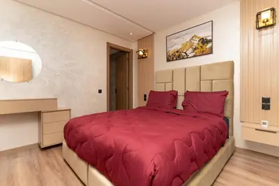 a bedroom with a large bed with red pillows at Home Holiday pool-Guéliz, Marrakech in Marrakech