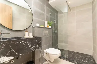a bathroom with a toilet and a mirror at Home Holiday pool-Guéliz, Marrakech in Marrakech