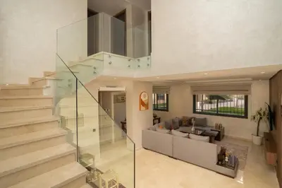 a living room with a glass staircase in a house at Home Holiday pool-Guéliz, Marrakech in Marrakech