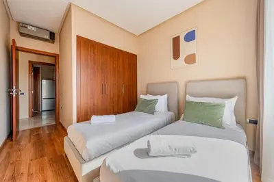 two beds in a small room with at Prestigia Jubaea Apartment Green Escape & Pool in Marrakech