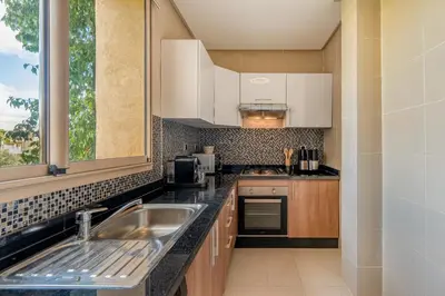 a kitchen with a sink and a window at Prestigia Jubaea Apartment Green Escape & Pool in Marrakech