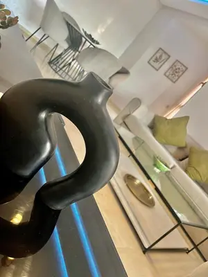 a black chair sitting on top of a stove at Marrakech Prestigia Center Pool View 3 Bedrooms in Marrakech