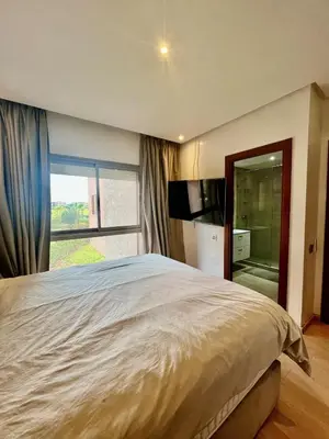 a bedroom with a large bed and a large window at Marrakech Prestigia Center Pool View 3 Bedrooms in Marrakech