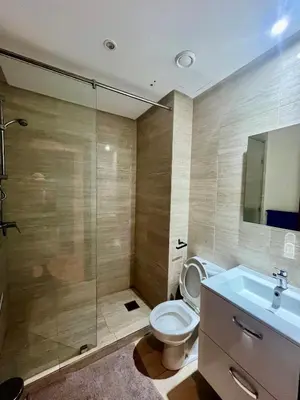 a bathroom with a toilet and a sink and a shower at Marrakech Prestigia Center Pool View 3 Bedrooms in Marrakech