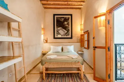 a small bedroom with a bed and a window at Riad Imani-Gorgeous Sunny Terrace Breakfast Pool in Marrakech