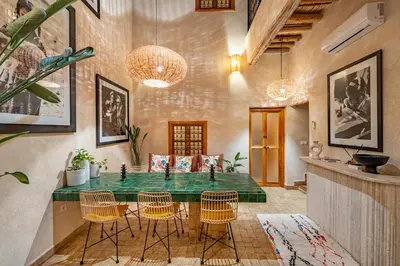 a dining room with a green table and chairs at Riad Imani-Gorgeous Sunny Terrace Breakfast Pool in Marrakech