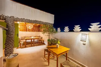 a room with a table and a dining room at Riad Imani-Gorgeous Sunny Terrace Breakfast Pool in Marrakech