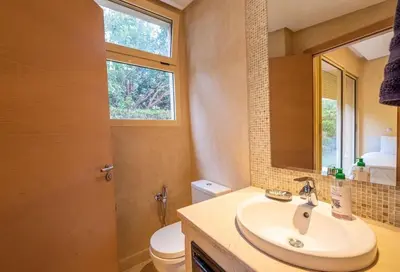 a bathroom with a sink and a toilet and a mirror at Luxury Villa Inspired by Authentic Moroccan Design in Marrakech