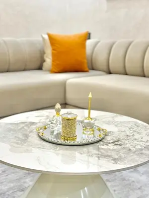 a coffee table with two candles on it with a couch at Elegant apartment with pool, highly desirable area in Marrakech