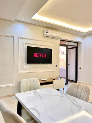 a meeting room with a television on the wall at Elegant apartment with pool, highly desirable area in Marrakech