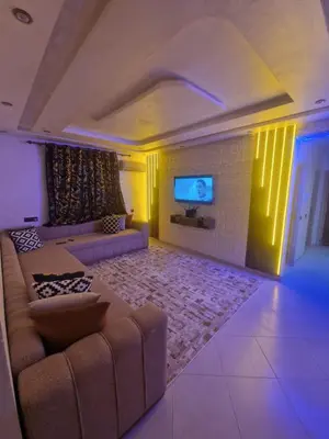 a living room with a couch and a flat screen tv at Appartement Marrakech in Marrakech