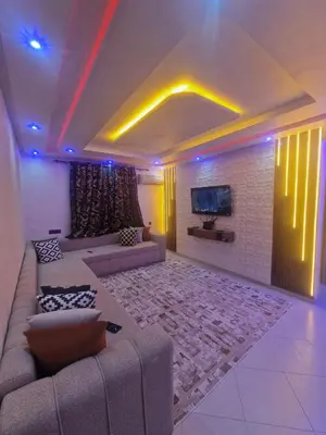 a living room with a couch and a tv at Appartement Marrakech in Marrakech