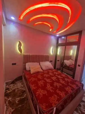 a bedroom with a bed with a red ceiling at Appartement Marrakech in Marrakech