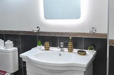 a bathroom with a white sink and a mirror at Cosy appartement en plein cœur de Marrakech ! in Marrakech