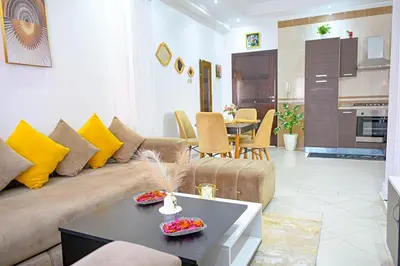 a living room with a couch and a table at Cosy appartement en plein cœur de Marrakech ! in Marrakech
