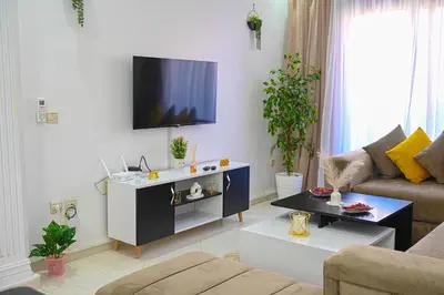 a living room with a flat screen tv on a wall at Cosy appartement en plein cœur de Marrakech ! in Marrakech