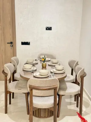 a dining room with a table and chairs at Modern apartment with jacuzzi & gym in Marrakech