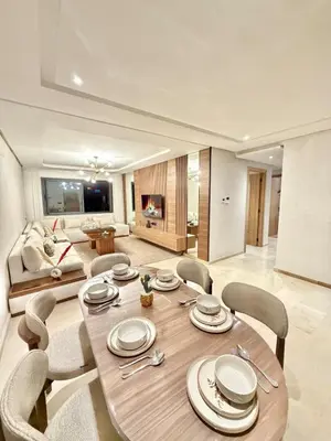 a dining room table and chairs in a living room at Modern apartment with jacuzzi & gym in Marrakech