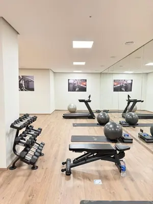 a gym with lots of exercise equipment in a room at Apartment with pool & gym in Marrakech