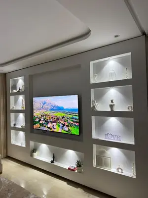 a living room with a flat screen tv on a wall at Apartment with pool & gym in Marrakech