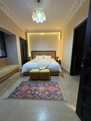 a bedroom with a large bed and a rug at Royal Moroccan House in Marrakech