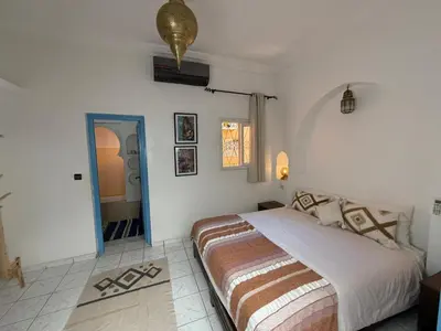 a bedroom with a large bed in a room at Riad Tanina Rooftop Central Authentic Moroccan Experience in Marrakech