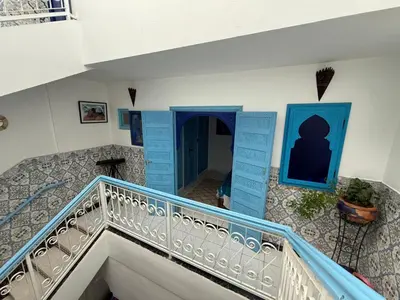 a staircase in a house with blue and white at Riad Tanina Rooftop Central Authentic Moroccan Experience in Marrakech