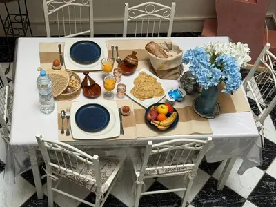 a white table with blue plates and food on it at Riad Tanina Rooftop Central Authentic Moroccan Experience in Marrakech