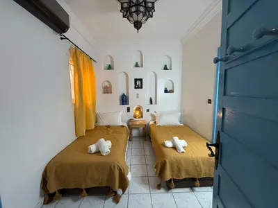 a room with two beds with towels on them at Riad Tanina Rooftop Central Authentic Moroccan Experience in Marrakech