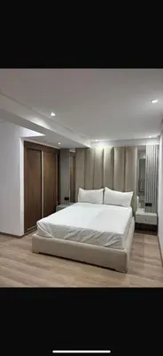 a bedroom with a large white bed in it at Modern marrakech duplex in Marrakech
