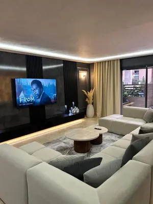 a living room with white furniture and a flat screen tv at Modern marrakech duplex in Marrakech