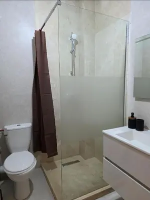 a bathroom with a shower and a toilet and a sink at Oasis Argan Garden Apartment Golf Argan Marrakech Pool 10min Airport in Marrakech