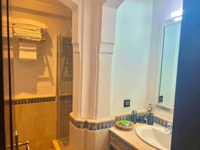 a bathroom with a sink and a mirror at Azou Luxury apartment - Pool & Garden Marrakech in Marrakech