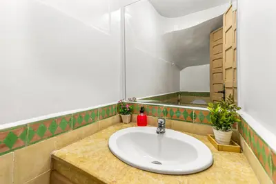 a bathroom with a sink and a mirror at Riad melyssa in Marrakech