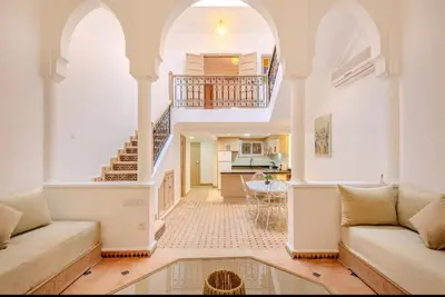 a living room with a couch and a staircase at Riad melyssa in Marrakech