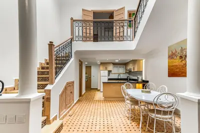a kitchen and dining room with a table and chairs at Riad melyssa in Marrakech